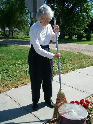 Mom sweeping sidewalk